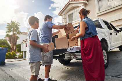Family loading cardboard boxes